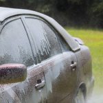 During cleaning washing in a car wash with using soap water on power water jet spraying